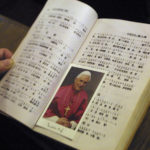 
              FILE - A picture of Pope Benedict XVI is seen between the pages of a hymn book during Mass at a church in Beijing, China, on Dec. 25, 2005. As soon as he was elected, Benedict moved decisively on a few select fronts: He made clear early on that he wanted to re-establish diplomatic relations with China that were severed in 1951. The Vatican announced Saturday Dec. 31, 2022 that Benedict, the former Joseph Ratzinger, had died at age 95. (AP Photo, File)
            