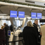 
              Passengers wait in line to check in for their flights at Southwest Airlines service desk at LaGuardia Airport, Tuesday, Dec. 27, 2022, in New York. The U.S. Department of Transportation says it will look into flight cancellations by Southwest that have left travelers stranded at airports across the country amid an intense winter storm.  (AP Photo/Yuki Iwamura)
            