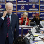 
              President Joe Biden speaks on the phone while visiting a phone bank at International Brotherhood of Electrical Workers Local 103, Friday, Dec. 2, 2022, in Boston. (AP Photo/Patrick Semansky)
            