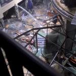 
              Following the burst of a huge aquarium, the atrium of a hotel is devastated in Berlin Germany, Friday, Dec. 16, 2022. German police say a huge aquarium in the center of Berlin has burst, causing a wave of devastation in and around the Sea Life tourist attraction. The words in Hebrew reads: 'The Aquarium exploded'. (instagram/tnn/dpa via AP)
            