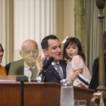 
              Assemblyman Anthony Rendon holds his daughter Vienna as he is accompanied by his wife Annie Lam and father Tom Rendon while he is sworn in as Speaker of the Assembly by California Supreme Court Justice Patricia Guerrero during the opening session of the California Legislature in Sacramento, Calif., Monday, Dec. 5, 2022. The legislature returned to work on Monday to swear in new members and elect leaders for the upcoming session. (AP Photo/José Luis Villegas Pool)
            