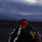 
              An offering sits among blackened lava rock from a previous eruption near the Mauna Loa volcano as it erupts Wednesday, Nov. 30, 2022, near Hilo, Hawaii. (AP Photo/Gregory Bull)
            