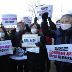 
              Protesters shout slogans during a rally to oppose Japan's adoption of a new national security strategy near the Japanese Embassy in Seoul, South Korea, Tuesday, Dec. 20, 2022. North Korea threatened Tuesday to take "bold and decisive military steps" against Japan as it slammed Tokyo's adoption of a national security strategy as an attempt to turn the country into an aggressive military power. The banners read "Stop military cooperation between South Korea, the U.S. and Japan military alliance." (AP Photo/Ahn Young-joon)
            