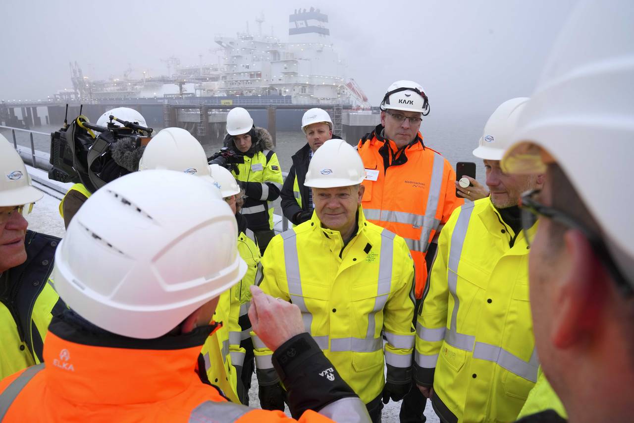 German Chancellor Olaf Scholz, center, listens during an event in front of the 'Hoegh Esperanza' Fl...