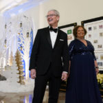 
              Apple CEO Tim Cook and Lisa Jackson, former administrator of the Environmental Protection Agency, arrive for the State Dinner with President Joe Biden and French President Emmanuel Macron at the White House in Washington, Thursday, Dec. 1, 2022. (AP Photo/Susan Walsh)
            