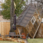 
              A greenhouse sits on a fence in the backyard of Randy Popiel's home after a possible tornado in Grapevine, Texas, Tuesday, Dec. 13, 2022. (Elías Valverde II/The Dallas Morning News via AP)
            