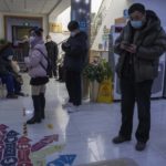 
              Visitors stand in the waiting area of a community health clinic in Beijing, Thursday, Dec. 15, 2022. A week after China eased some of the world's strictest COVID-19 containment measures, uncertainty remains over the direction of the pandemic in the world's most populous nation. (AP Photo/Ng Han Guan)
            