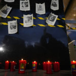 
              FILE - Photos of slain journalists are displayed on a wall during a vigil to protest the murder of journalist Fredid Roman, outside Mexico's Attorney General's office in Mexico City, Wednesday, Aug. 24, 2022. Roman was the 15th media worker killed so far this year in Mexico, where it is now considered the most dangerous country for reporters outside a war zone. (AP Photo/Eduardo Verdugo, File)
            