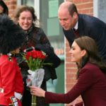 
              Henry Dynov-Teixeira, 8, of Somerville, presents flowers to Britain's Prince William and Kate, Princess of Wales, as his parents Melissa, left, and Irene, look on following a visit to Greentown Labs, Thursday, Dec. 1, 2022, in Somerville, Mass.   (Angela Weiss Pool Photo via AP)
            