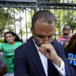 
              Mona Hardin, background left in green, mother of Ronald Greene, prays outside the gates of the governor's mansion in Baton Rouge, La., May 27, 2021, protesting the death of Greene, who died in the custody of Louisiana State Police in 2019. Foreground is Ron Haley, attorney for the Greene family. (AP Photo/Gerald Herbert)
            