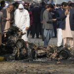 
              Investigators collect evidence from the wreckage of a car at the site of bomb explosion, in Islamabad, Pakistan, Friday, Dec. 23, 2022. A powerful car bomb detonated near a residential area in the capital Islamabad on Friday, killing some people, police said, raising fears that militants have a presence in one of the country's safest cities. (AP Photo/Anjum Naveed)
            