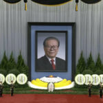 
              In this image taken from video footage run by China's CCTV, honor guard members stand near a giant portrait of late former Chinese President Jiang Zemin during a formal memorial held at the Great Hall of the People in Beijing on Tuesday, Dec. 6, 2022. (CCTV via AP)
            