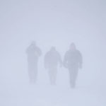 
              Three men walk down Richmond Avenue in whiteout conditions during a sustained blizzard in Buffalo, N.Y. on Saturday, Dec. 24, 2022. (Derek Gee/The Buffalo News via AP)
            