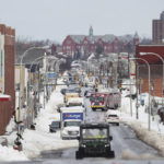 
              Vehicles drive down Jefferson Avenue in Buffalo. N.Y., on Wednesday, Dec. 28, 2022. Clean-up efforts remain underway after a blizzard hit four Western New York counties. (Joseph Cooke//The Buffalo News via AP)
            