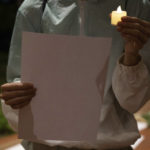 
              Thomas So, who did not want to show his face for fear of retribution, holds up an electric candle and a blank paper during a protest at the University of Hong Kong in Hong Kong, Tuesday, Nov. 29, 2022. The recent wave of protests against China's anti-virus restrictions was a ray of hope for some supporters of Hong Kong's own pro-democracy movement after local authorities stifled it using a national security law enacted in 2020, but not everyone agrees. (AP Photo/Bertha Wang)
            