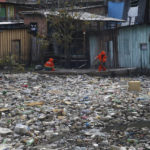 
              FILE - City workers remove garbage floating on the Negro River, which has a rising water level due to rain, in Manaus, Amazonas state, Brazil, June 6, 2022. More than 2,000 experts plan to wrap up early negotiations Friday, Dec. 2, on plastic pollution at one of the largest global gatherings ever to address the crisis. (AP Photo/Edmar Barros, File)
            