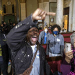 Protesters react after Los Angeles City Council member Kevin de Leon casts a vote to ratify a state of emergency on homelessness during the Los Angeles City Council meeting Tuesday, Dec. 13, 2022, in Los Angeles. A small group of protesters chanted during the meeting calling for the resignation of Councilman de Leon. (AP Photo/Ringo H.W. Chiu)