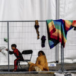 
              FILE - Children play with stones at an Afghan refugees camp on Joint Base McGuire Dix Lakehurst, N.J., Sept. 27, 2021. Military bases that housed tens of thousands of Afghan refugees after the U.S. airlifted them out of Kabul last year incurred almost $260 million in damages that in some cases rendered buildings unusable for troops until they get significant repairs to walls and plumbing, the Pentagon’s inspector general found. Tens of thousands of Afghan refugees were flown to eight military bases in the U.S. where many of them lived for months while they waited fro visa processing and resettlement. (AP Photo/Andrew Harnik, File)
            