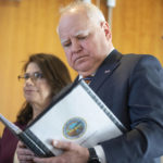 
              FILE - Minnesota Gov. Tim Walz reviews notes before speaking about the state's budget Tuesday, Dec. 6, 2022, at the Minnesota Department of Revenue in St. Paul, Minn. Minnesota is projecting a record $17.6 billion surplus for the next budget. Walz says the state can afford to provide tax rebates and increase spending on education and infrastructure. (Alex Kormann/Star Tribune via AP, File)
            