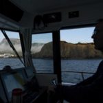 
              Joel Berthelot pilots his boat along the coast of Perce, Quebec, Canada, just after sunrise, Tuesday, Sept. 13, 2022. Against the ravaging seas, Quebec's coastal communities have learned through experience that the way to advance against climate change is to retreat. (AP Photo/Carolyn Kaster)
            