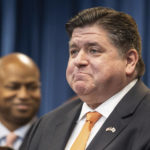 
              Illinois Gov. J.B. Pritzker reacts after signing House Bill 4664, a bill that will further protect reproductive health care providers and patients who are seeking care in Illinois, Friday, Jan. 13, 2023, in Chicago. (Pat Nabong/Chicago Sun-Times via AP)
            