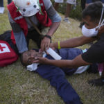 
              Paramedics assist an injured anti-government protester during a protest demanding the resignation of President Dina Boluarte, the release from prison of ousted President Pedro Castillo and immediate elections in Lima, Peru, Thursday, Jan. 26, 2023. From January 19 to 24, Doctors Without Borders treated 73 patients at the Lima protests suffering from exposure to tear gas, pellet wounds, contusions or psychological distress, the non-profit organization said. (AP Photo/Guadalupe Pardo)
            