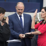 
              Florida Lt. Gov. Jeanette Nunez, right, is sworn in by Justice John Curiel as her husband Adrian, center, looks on during an inauguration ceremony at the Old Capitol, Tuesday, Jan. 3, 2023, in Tallahassee, Fla. (AP Photo/Lynne Sladky)
            