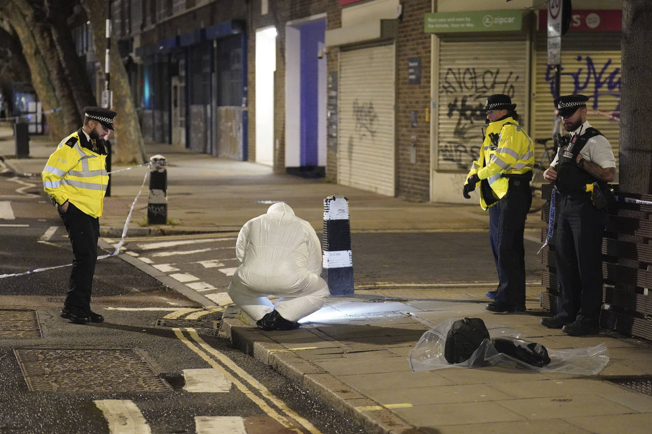 A police forensics officer works near to the scene of a suspected  drive-by shooting, in north Lond...