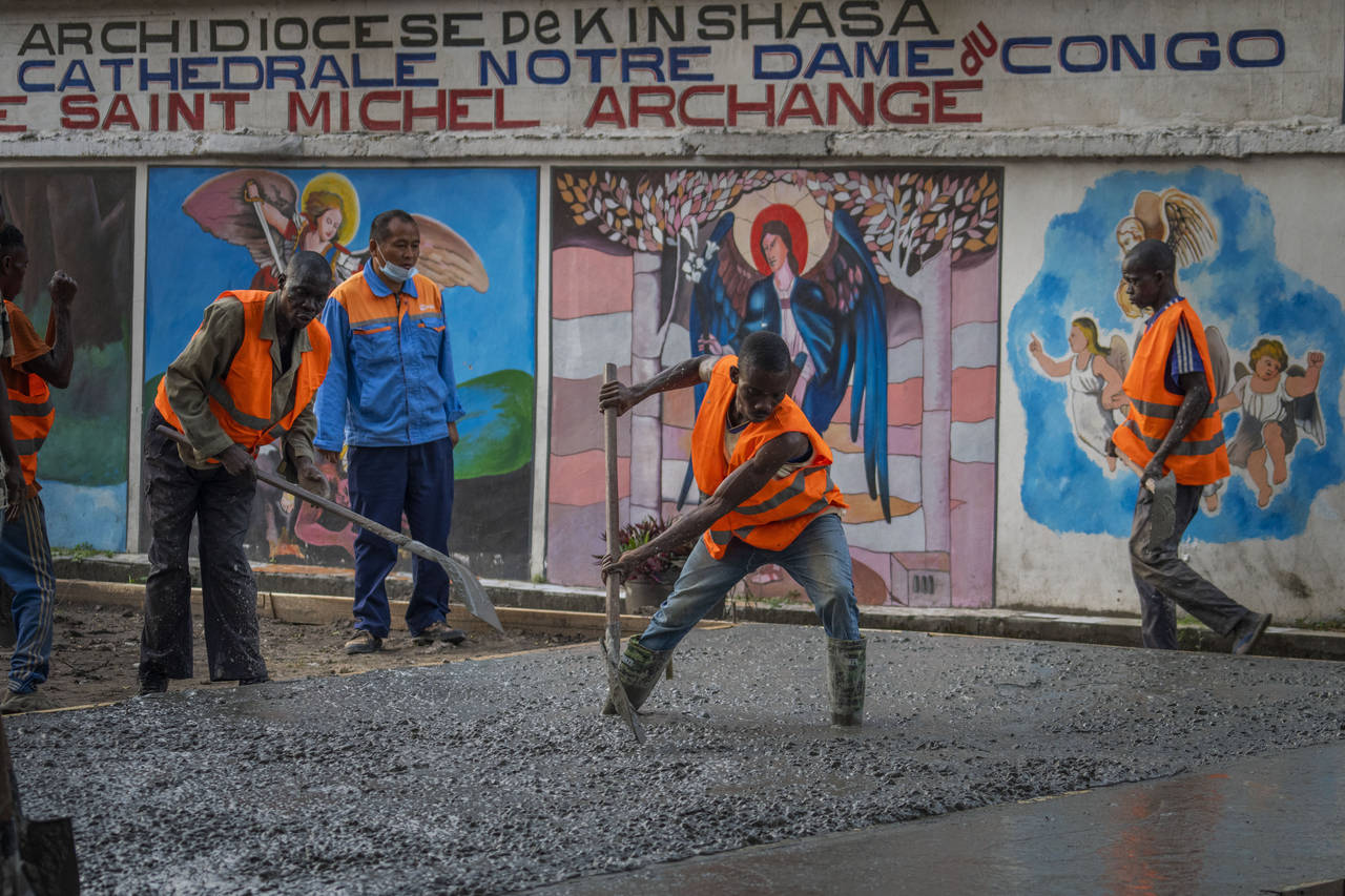Construction workers lay concrete outside the Cathedral Notre Dame du Congo in Kinshasa, Democratic...