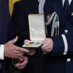 
              A military aide hands a Presidential Citizens Medal, the nation's second-highest civilian honor, to President Joe Biden as a citation is read for U.S. Capitol Police officer Caroline Edwards during a ceremony to mark the second anniversary of the Jan. 6 assault on the Capitol in the East Room of the White House in Washington, Friday, Jan. 6, 2023. (AP Photo/Patrick Semansky)
            