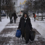 
              CORRECTS DAY OF THE WEEK  A woman walks in central Kyiv, Ukraine, Tuesday Jan. 31, 2023. (AP Photo/Daniel Cole)
            