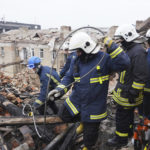 
              Ukrainian emergency workers clear the rubble on the roof of a residential building which was hit by a Russian rocket at the city center of Kharkiv, Ukraine, Monday, Jan. 30, 2023. Russian shelling killed at least five people and wounded 13 others during the previous 24 hours, Ukrainian authorities said Monday as the Kremlin’s and Kyiv’s forces remained locked in combat in eastern Ukraine. (AP Photo/Andrii Marienko)
            