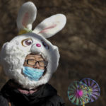 
              A woman wears a face mask and a rabbit headgear in freezing cold temperatures as she heads to a temple fair at the Yuanmingyuan Garden during the second day of the Lunar New Year celebrations in Beijing, Monday, Jan. 23, 2023. The Lunar New Year is the most important annual holiday in China. Each year is named after one of the 12 signs of the Chinese zodiac in a repeating cycle, with this year being the Year of the Rabbit. For the past three years, celebrations were muted in the shadow of the pandemic. (AP Photo/Andy Wong)
            