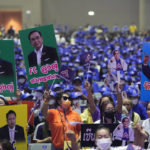 Supporters hold up posters of Thailand's Prime Minister Prayuth Chan-ocha as he officially announces joining the United Thai Nation Party as a newly-established party's candidate in Bangkok, Thailand, Monday, Jan. 9, 2023. Prayuth, who first came to power as army chief leading a coup in 2014, became prime minister in an elected government in 2019 as the candidate of the military-backed Palang Pracharath Party, but has split with his former colleagues to become the candidate for Ruam Thai Sang Chart, or United Thai Nation Party, in this year's not-yet-scheduled general election. (AP Photo/Sakchai Lalit)