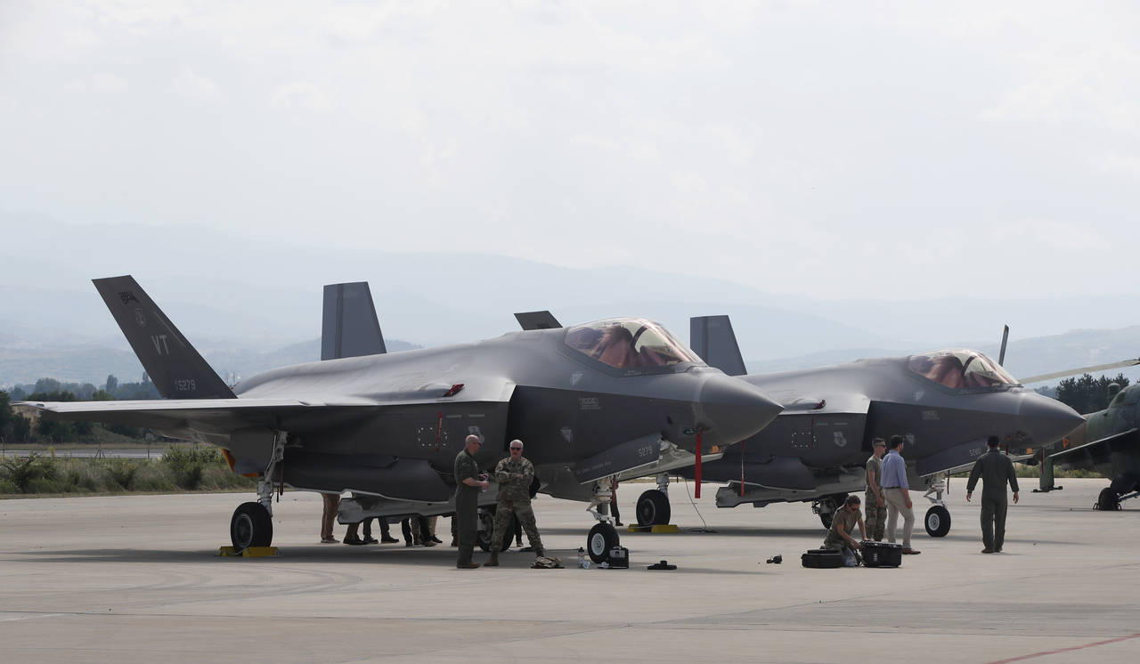 FILE - U.S. military personnel work near F-35 fighter jet of the Vermont Air National Guard, parked...