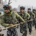 
              Indian soldiers hold rope as they guard India's opposition Congress party leader Rahul Gandhi, and other leaders during a 5-month-long "Unite India March," in Srinagar, Indian controlled Kashmir, Sunday, Jan. 29, 2023. The countrywide trek, that began from the southernmost tip of India, on Sept. 7., is expected to traverse 3,570 kilometers (2,218 miles) and cross 12 states before finishing in Indian-controlled Kashmir. (AP Photo/Mukhtar Khan)
            