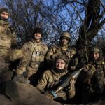 
              Ukrainian servicemen gather for a group photo at their position on the frontline near Bakhmut, Donetsk region, Ukraine, Wednesday, Jan. 11, 2023. (AP Photo/Evgeniy Maloletka)
            