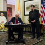 
              President Joe Biden signs a condolence book at the Apostolic Nunciature of the Holy See in Washington, Thursday, Jan. 5, 2023, for Pope Emeritus Benedict XVI. Benedict died at 95 on Dec. 31, 2022, in the monastery on the Vatican grounds where he had spent nearly all of his decade in retirement. Archbishop Christophe Pierre, Apostolic Nuncio to the United States, looks on at right. (AP Photo/Patrick Semansky)
            