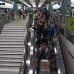 
              Passengers head to departure hall at Lok Ma Chau station following the reopening of crossing border with mainland China, in Hong Kong, Sunday, Jan. 8, 2023. Travelers crossing between Hong Kong and mainland China, however, are still required to show a negative COVID-19 test taken within the last 48 hours, a measure China has protested when imposed by other countries. (AP Photo/Bertha Wang)
            