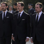 
              CORRECTS THE NAME OF PRINCE ON THE RIGHT Prince Philippos, left, Prince Pavlos, center, and Prince Nikolaos right, sons of former king of Greece Constantine II stand behind their father coffin as they arrive at the Metropolitan cathedral for his funeral in Athens, Monday, Jan. 16, 2023. Constantine died in a hospital late Tuesday at the age of 82 as Greece's monarchy was definitively abolished in a referendum in December 1974. (AP Photo/Petros Giannakouris)
            