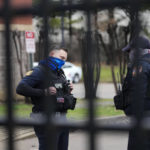 
              Memphis police stand behind a locked gate at a precinct as a group of demonstrators arrive outside to protest the death of Tyre Nichols, who died after being beaten by Memphis police officers, in Memphis, Tenn., Sunday, Jan. 29, 2023. (AP Photo/Gerald Herbert)
            