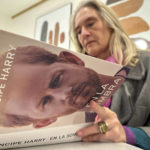 
              A woman poses for a photo as she opens a copy of "En La Sombra" (In the Shadow), the Spanish translation of Britain's Prince Harry's memoir, "Spare," in Barcelona, Spain, Thursday Jan. 5, 2023. Prince Harry alleges in a much-anticipated new memoir, due to be published next week, that his brother Prince William lashed out and physically attacked him during a furious argument over the brothers' deteriorating relationship. (AP Photo)
            