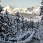 
              Vehicles travel along a snow-lined U.S. Route 50 the morning after a winter storm pelted the region with a large amount of snow, in South Lake Tahoe, Calif., Sunday, Jan. 1, 2023. (Stephen Lam/San Francisco Chronicle via AP)
            