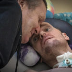 Serhii Shumei, 64, talks to his son Vitalii, 34, a Ukrainian officer heavily wounded in a battle with Russian forces, in a city hospital in Chernihiv, Ukraine, Wednesday, Jan. 11, 2023. Vitalii, a long-range anti-aircraft missile commander, was wounded in the Donbas region of eastern Ukraine that has become synonymous with horrific losses in ongoing fighting for both Ukraine and Russia. (AP Photo/Efrem Lukatsky)