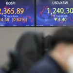 
              A currency trader works near the screens showing the Korea Composite Stock Price Index (KOSPI), left, and the foreign exchange rate between U.S. dollar and South Korean won at a foreign exchange dealing room in Seoul, South Korea, Wednesday, Jan. 11, 2023. Asian shares were mostly higher Wednesday, boosted by a rally on Wall Street that came ahead of some potentially market-moving reports due later in the week. (AP Photo/Lee Jin-man)
            