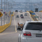 
              Cars cross the Tienditas International Bridge in San Antonio, Tachira state, Venezuela, Sunday, Jan. 1, 2023. Colombia and Venezuela on Sunday opened the bridge that was finished in 2016 but never inaugurated because years of political tensions. (AP Photo/Ferley Ospina)
            