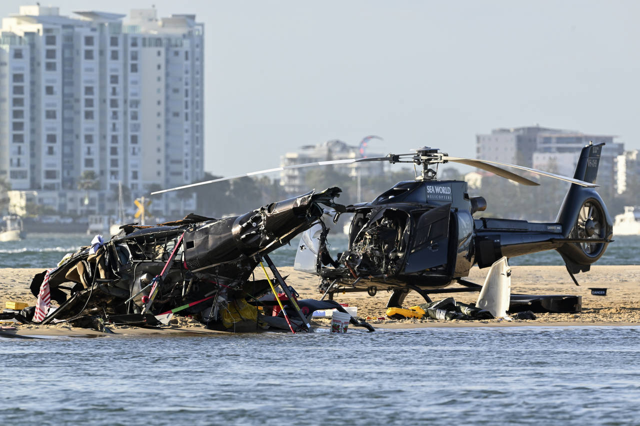 Two cashed helicopters sit on the sand at a collision scene near Seaworld, on the Gold Coast, Austr...