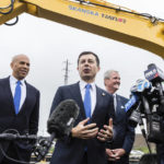 
              FILE - Sen. Cory Booker, D-N.J., Transportation Secretary Pete Buttigieg and N.J. Gov. Phil Murphy speak to the media after at a groundbreaking ceremony for the New Portal North Bridge project held in Kearny, N.J., Aug. 1, 2022. NJ Transit and Amtrak are replacing the century-old Portal Bridge over the Hackensack River in New Jersey doubling rail capacity between Newark and New York. (AP Photo/Stefan Jeremiah, File)
            