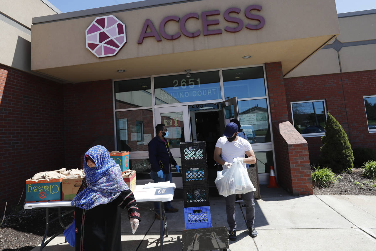 FILE - Workers at ACCESS, the Arab Community Center for Economic and Social Services, help with mea...