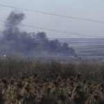 
              FILE - Smoke billows during fighting between Ukrainian and Russian forces in Soledar, Donetsk region, Ukraine, Wednesday, Jan. 11, 2023. Soledar and Bakhmut again highlighted a bitter rift between the top military brass and Yevgeny Prigozhin, a rogue millionaire whose Wagner Group military contractor has played an increasing role in Ukraine. (AP Photo/Libkos, File)
            